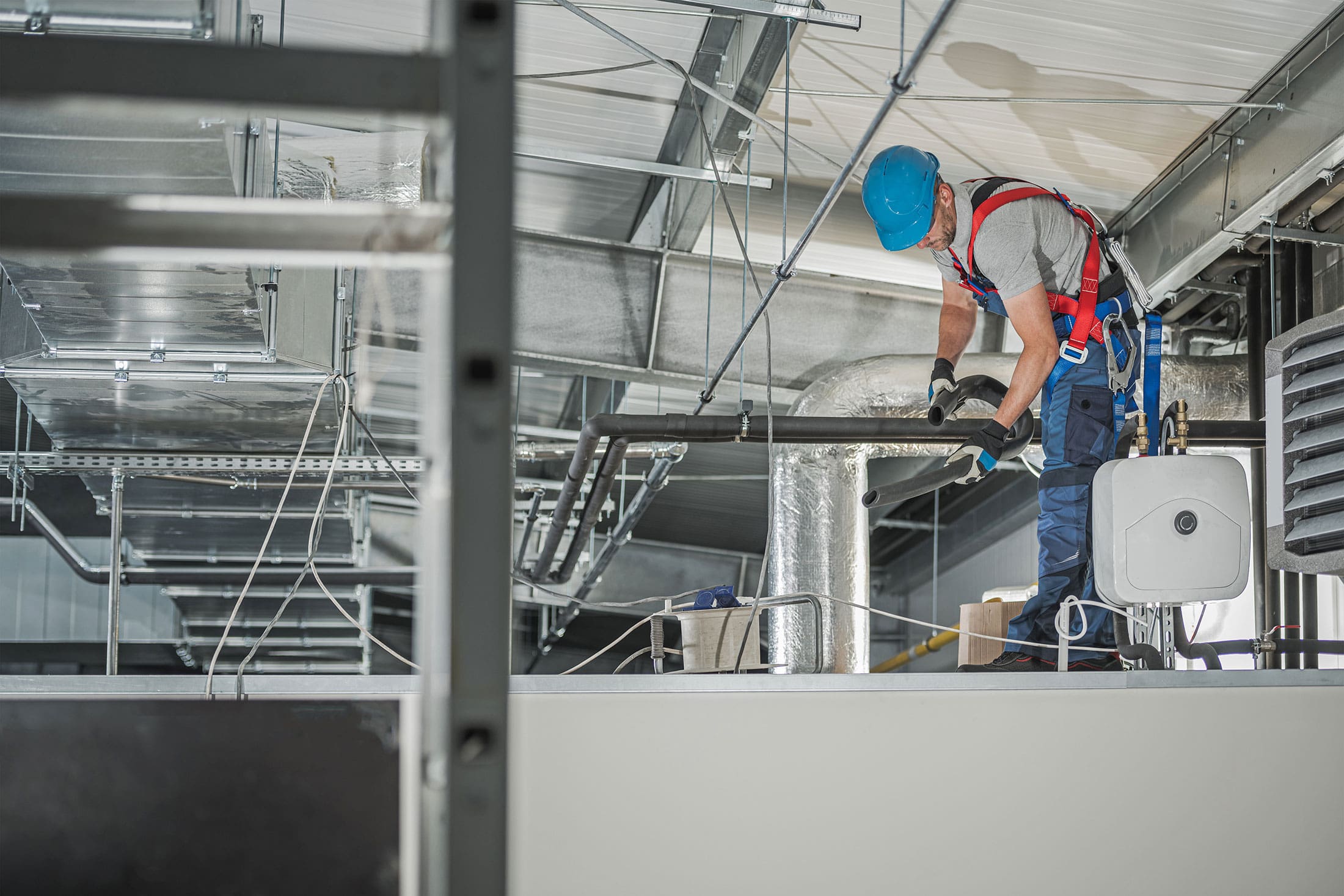 HVAC man testing and working in factory