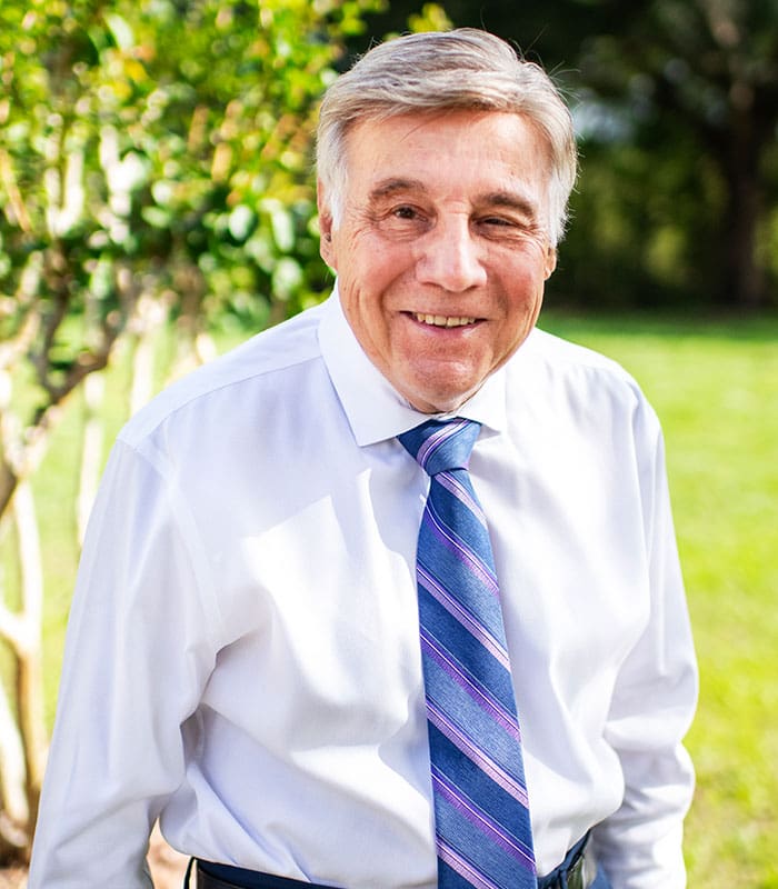 a picture of Charles W. Kaupp, The Sr. Vice President of SITA, posing and smiling for the picture