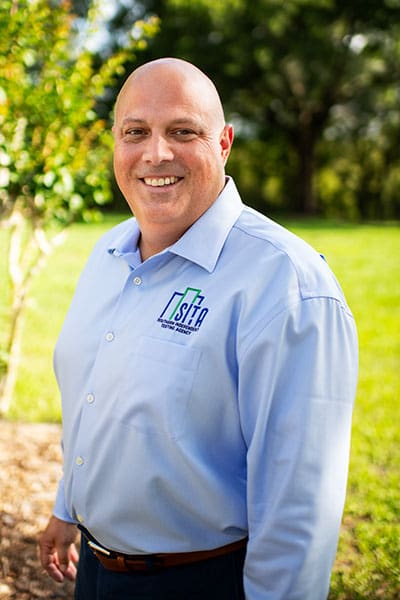 A headshot of brian kaupp outdoors smiling and posing