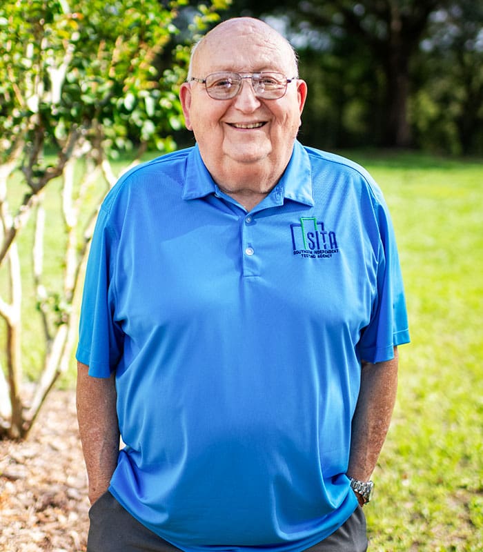 A headshot of Danny F. Brookhouser, TAB Specialist from SITA, smiling and posing outdoors