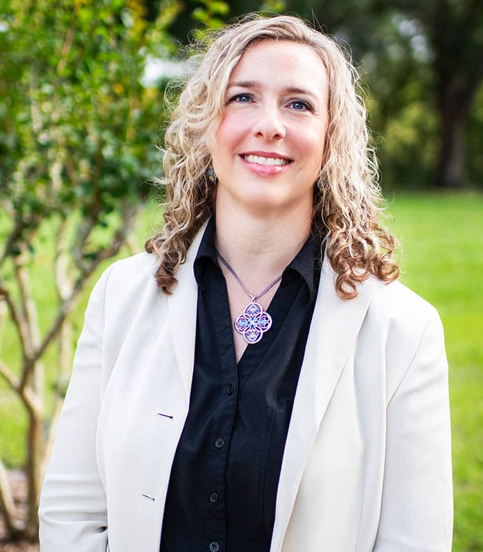 A headshot of Donna Peachy, Director of Operations from SITA smiling and posing outdoors