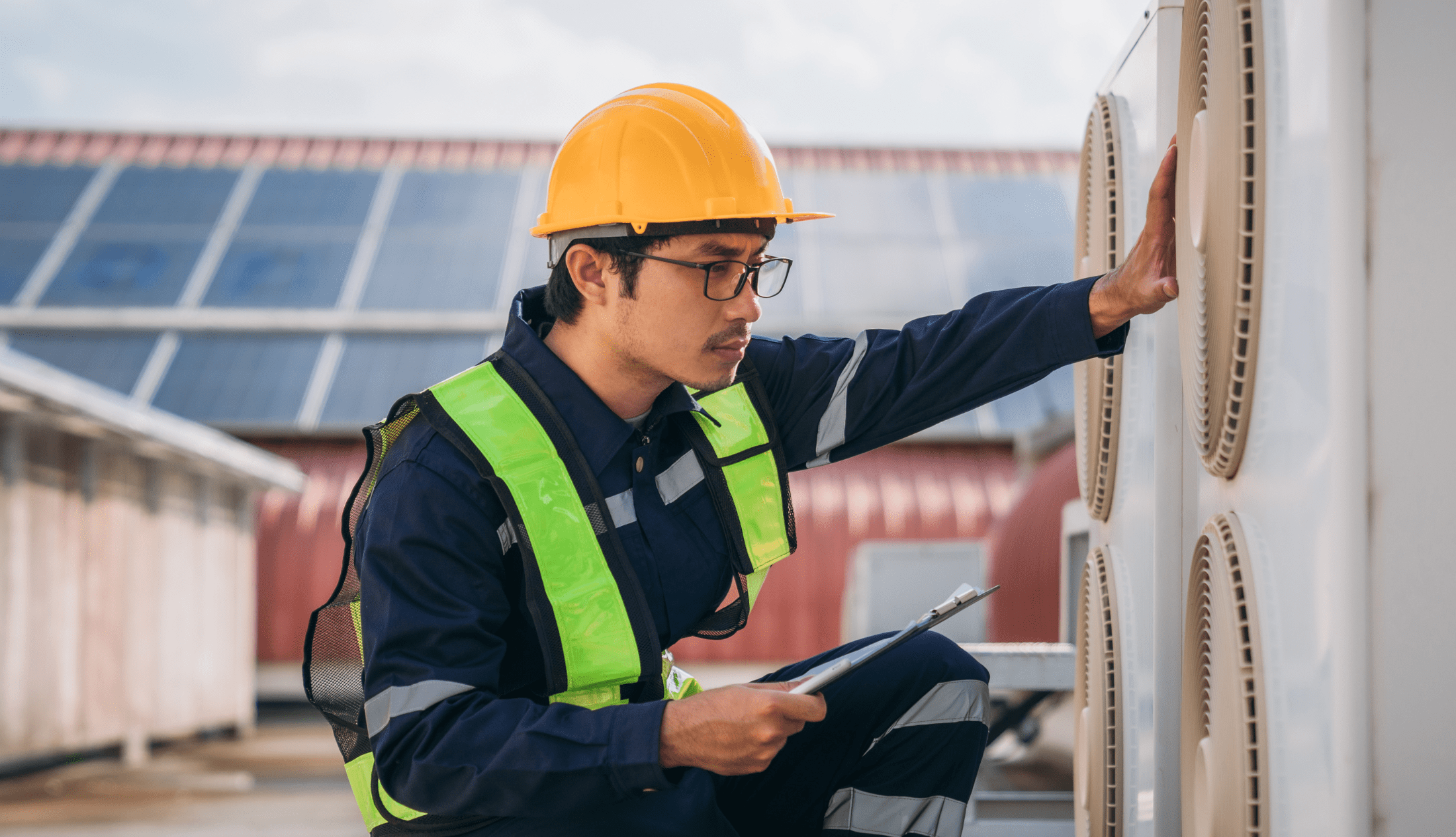 The Role of Proper TAB in Enhancing Indoor Air Quality and Occupant Comfort Engineers is checking the air conditioning cooling system of a major building.