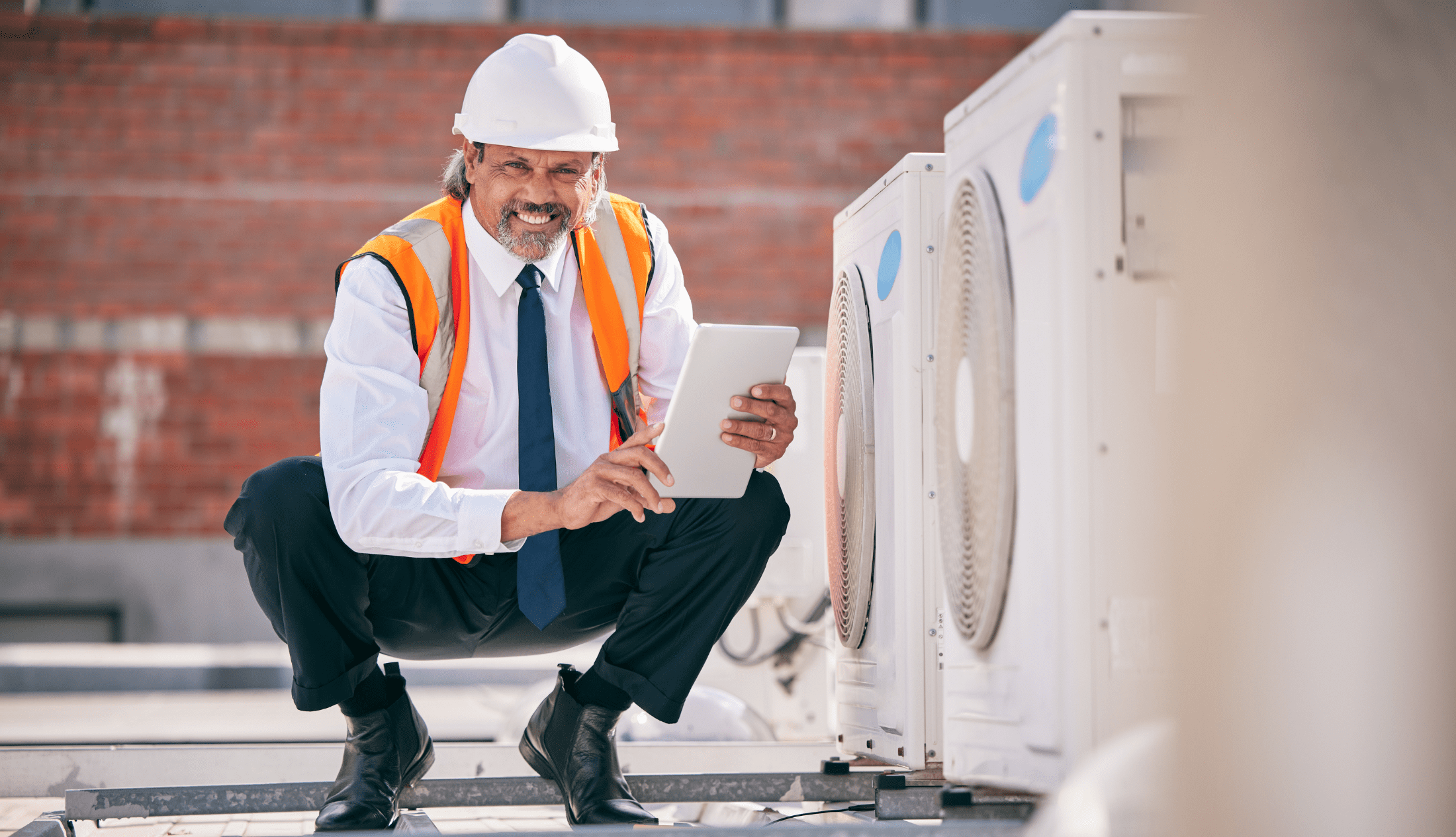 Weather Extremes and HVAC: Preparing Your Building for Climate Challenges Engineering man, air conditioner and tablet for HVAC power, heating generator or fan check | Weather Extremes and HVAC: Preparing Your Building for Climate Challenges