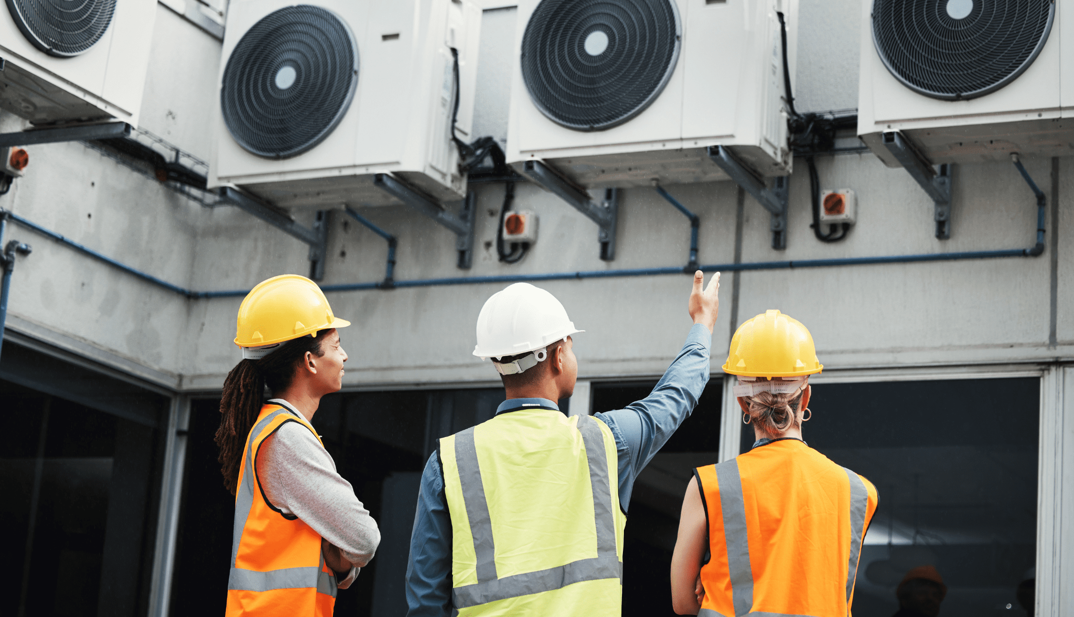 Energy Efficiency in Modern HVAC Systems Building, looking and employees doing maintenance inspection on warehouse air together.