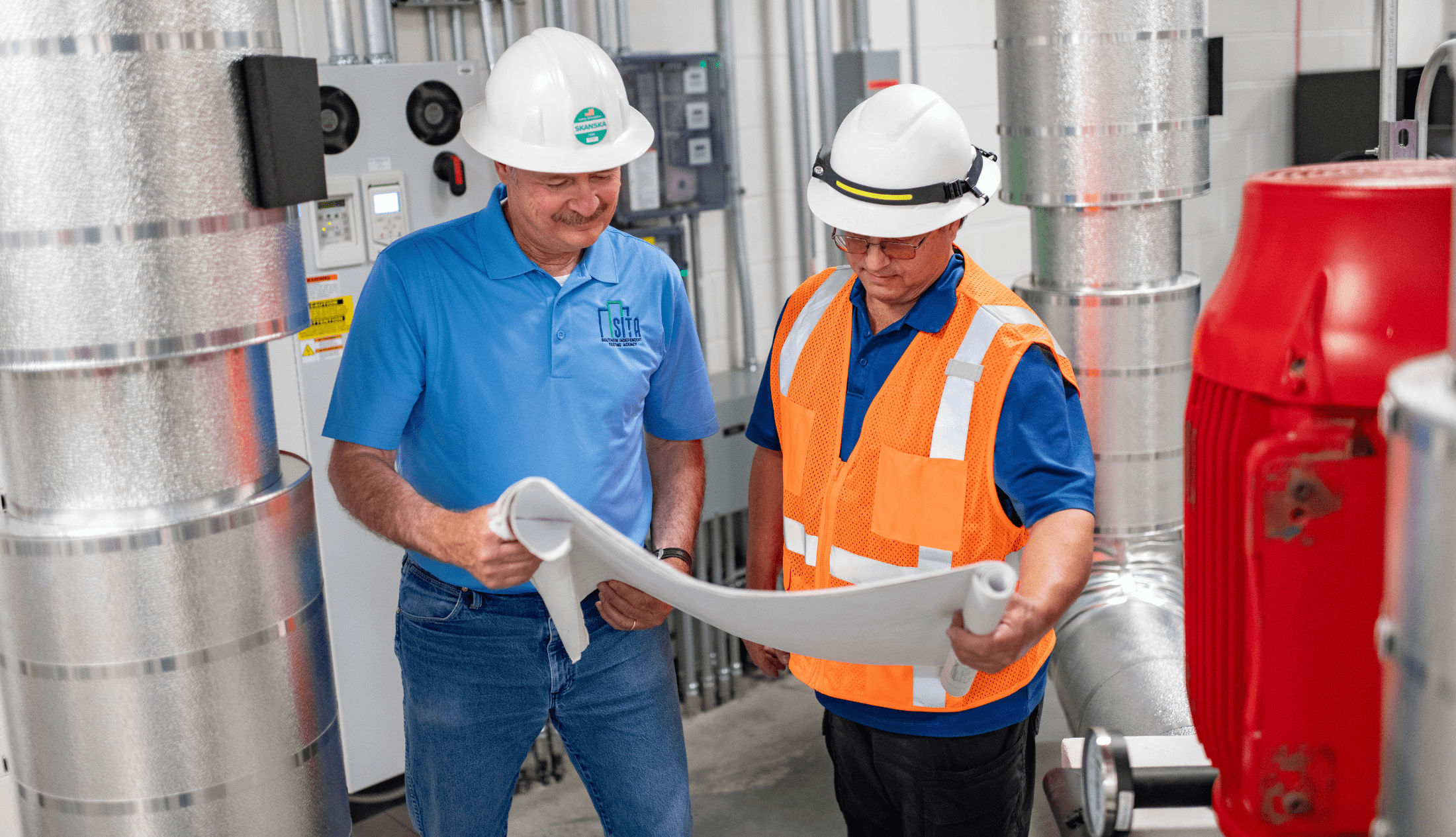 AABC vs. NEBB: Certification, Continuing Education, and Independence Testing, adjusting and balancing (TAB) specialists looking at building plans and making decisions on how to improve building efficiency.