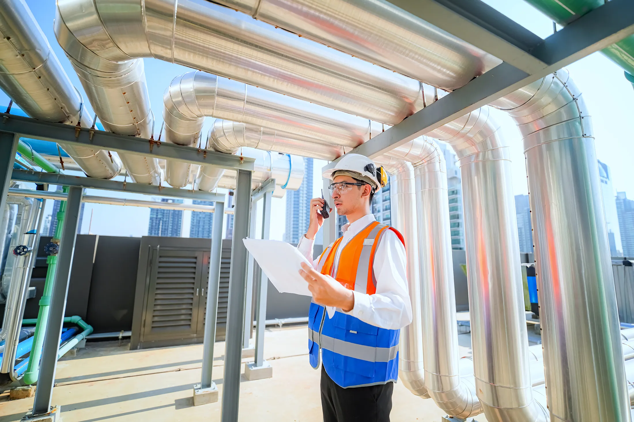 HVAC technician inspecting and testing commercial ductwork and ventilation systems to ensure proper air balance, energy efficiency, and system performance in a commercial building.
